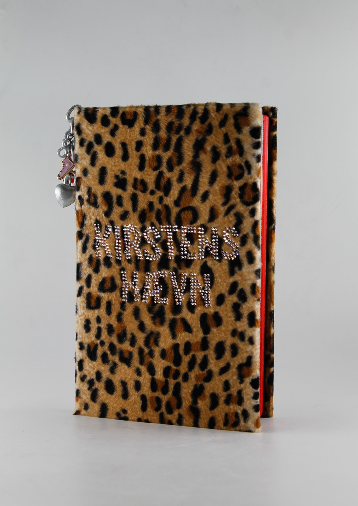 Picture of a book covered in leopard velour and rhinestones.