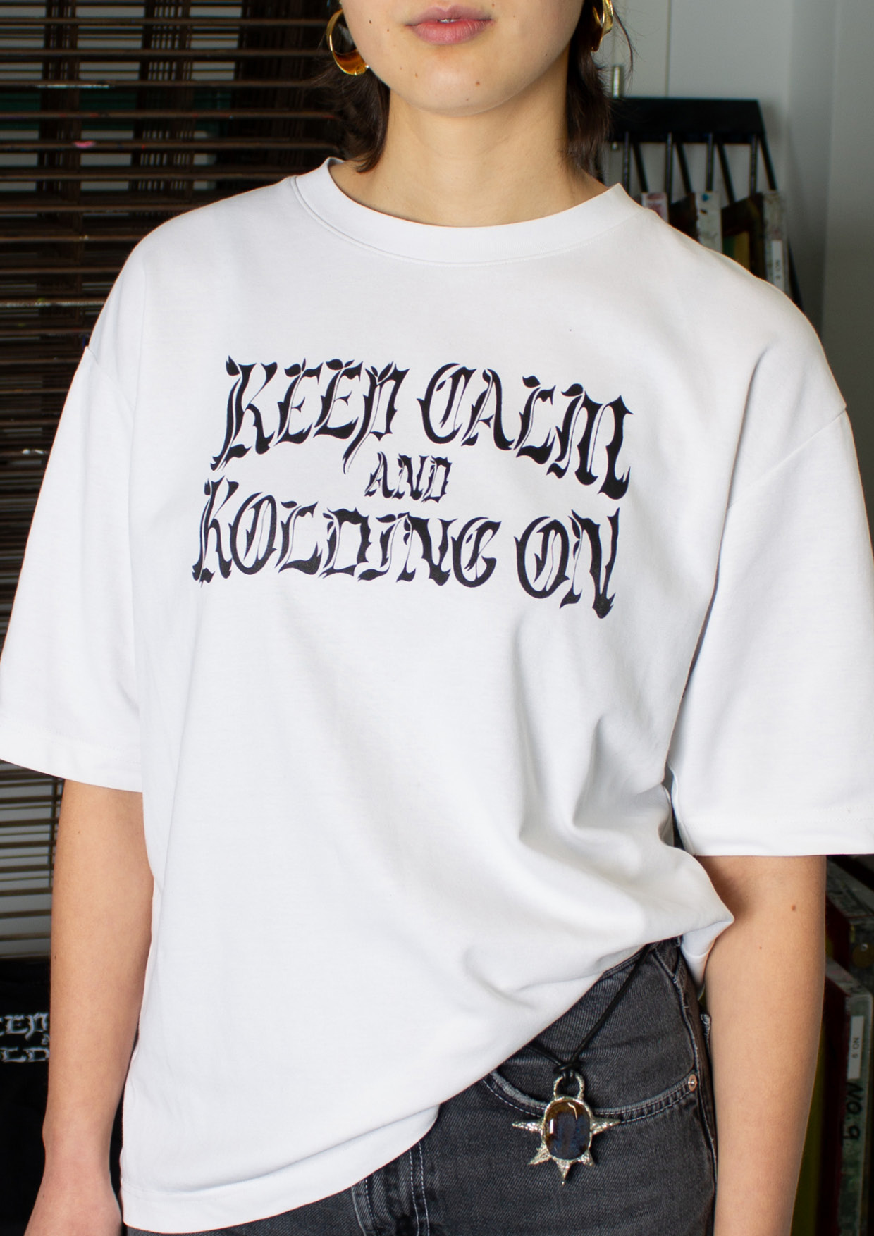 White t-shirt with illustrative typography printed in black.
