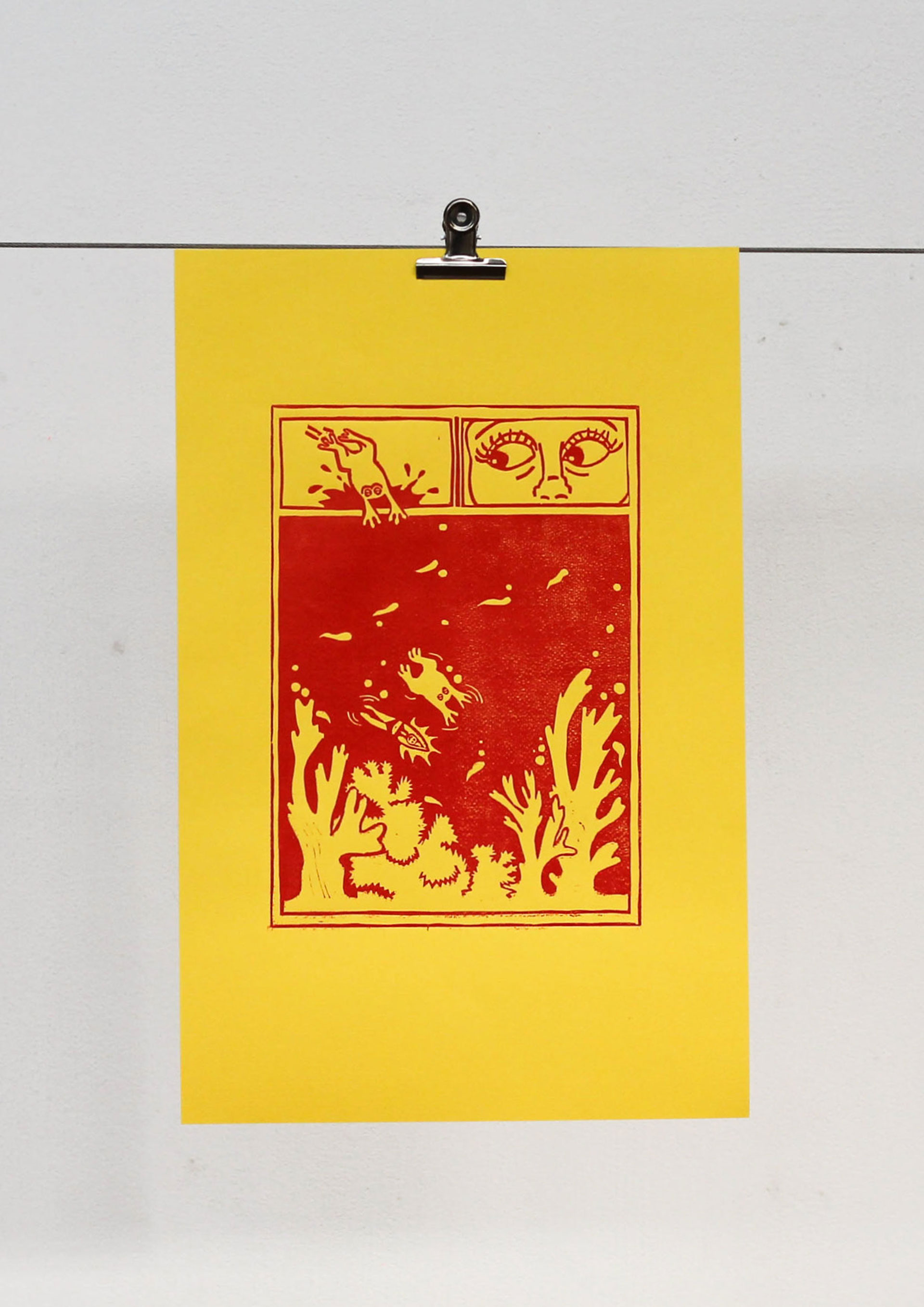 Yellow and red linocut of a girl and a frog swimming.