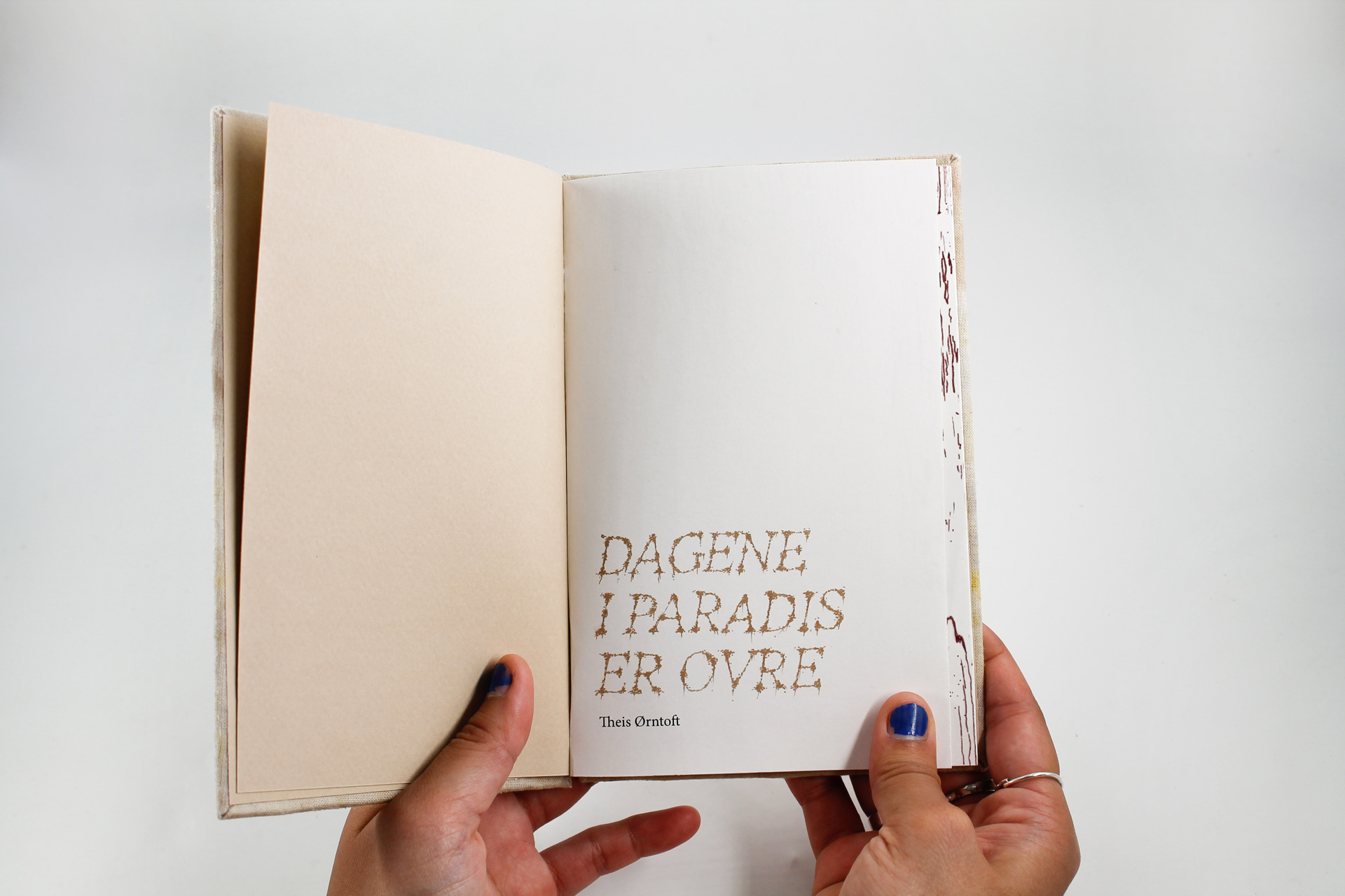 Open book with one side beige and one side white.