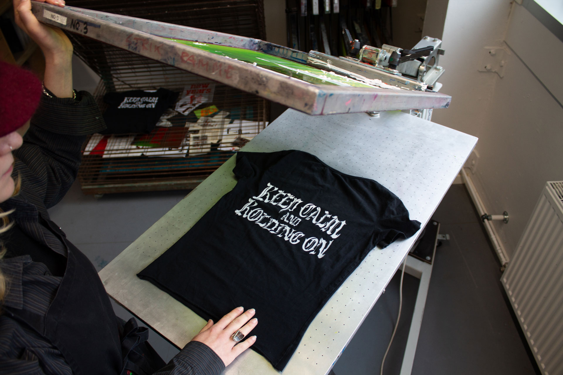 Black t-shirt getting silk screen printed on.