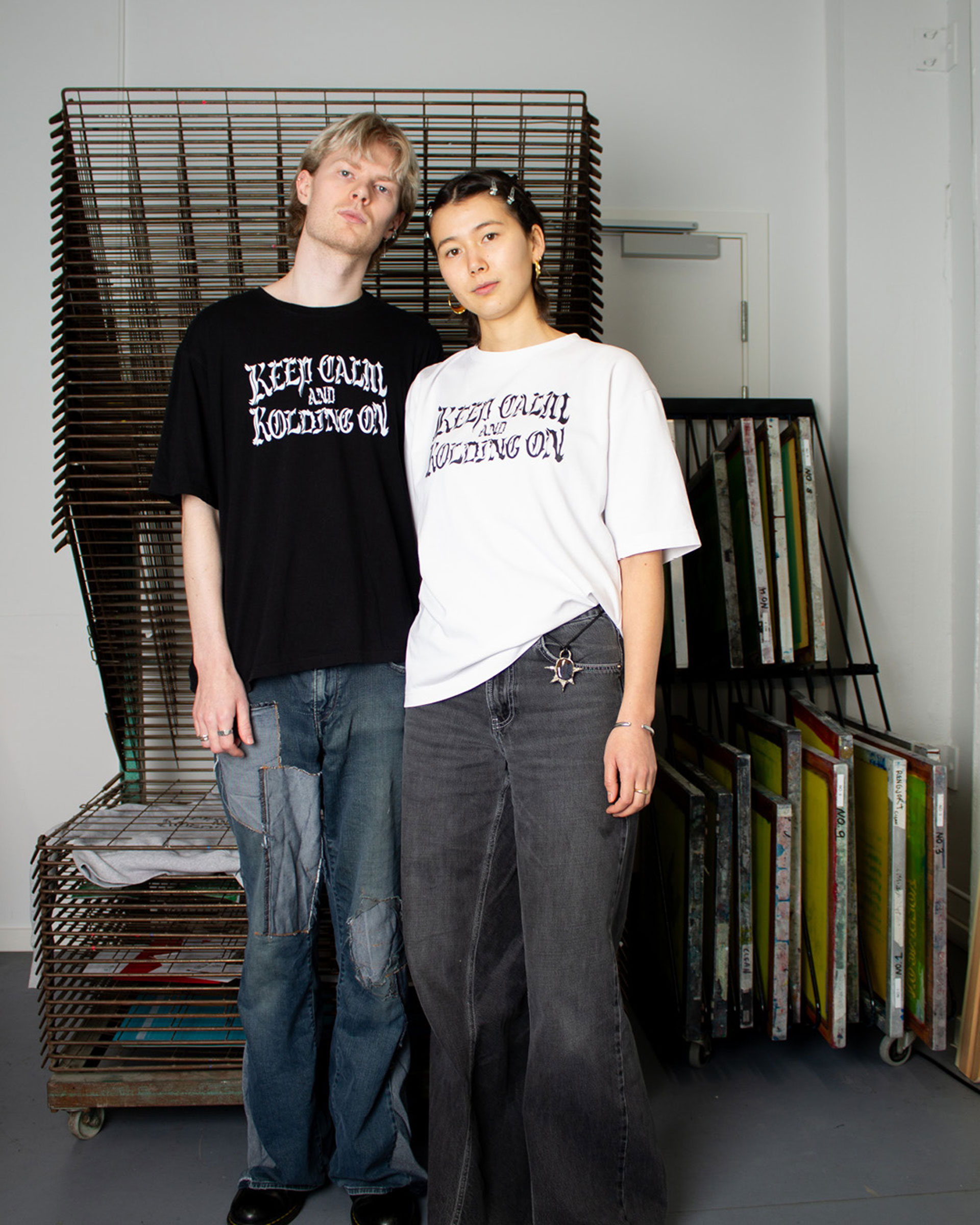Two people wearing t-shirts with the same print in opposite colors.