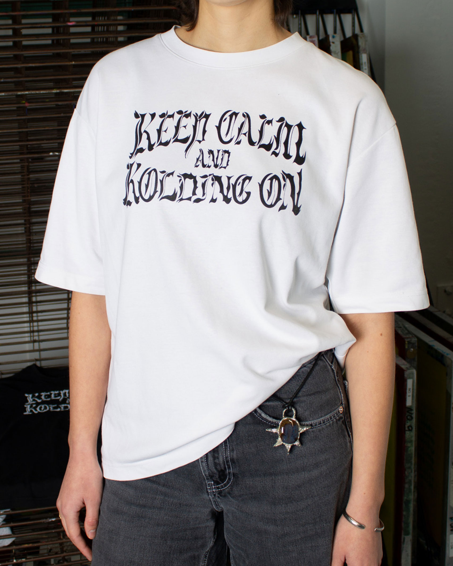 White t-shirt with black print of illustrative typography.